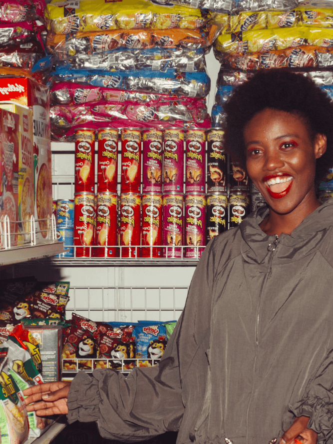 Smiling woman in a Spaza shop